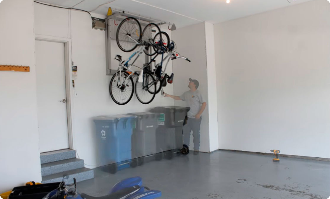 gentleman installing bike wall mount in garage