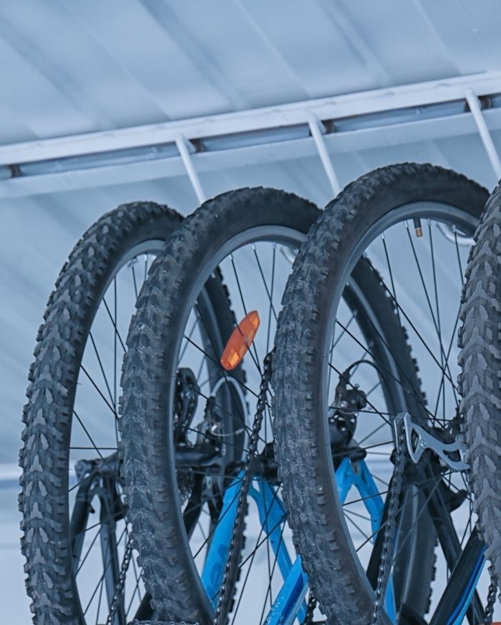 bicycles hanging from bike lift storage system